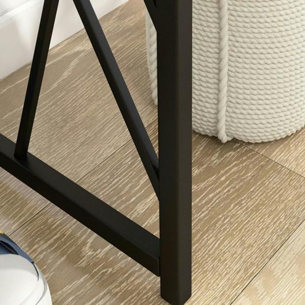 Black metal console table leg with angled cross-brace and grey tabletop edge