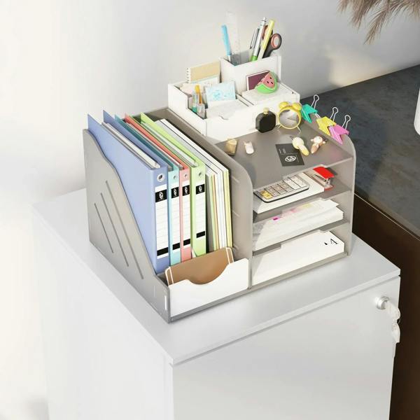 White filing cabinet with open top drawer holding binders and office supplies