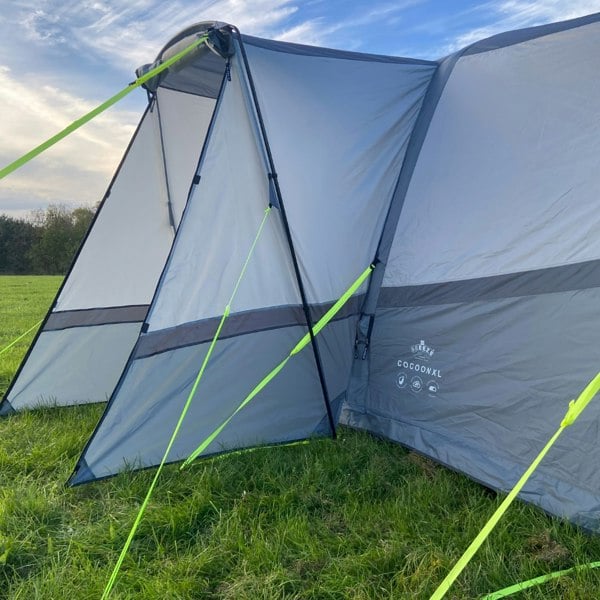 The Cocoon Breeze® XL v2 Motorhome Awning (Grey) from OLPRO pictured in a campsite and showing the side pod.