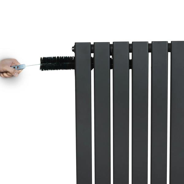 Flat single column radiator in anthracite grey, showcasing sleek vertical lines and a hand adjusting the top valve for temperature control