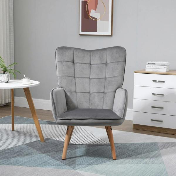 Grey upholstered wingback armchair with tufted back, padded seat, and wooden legs