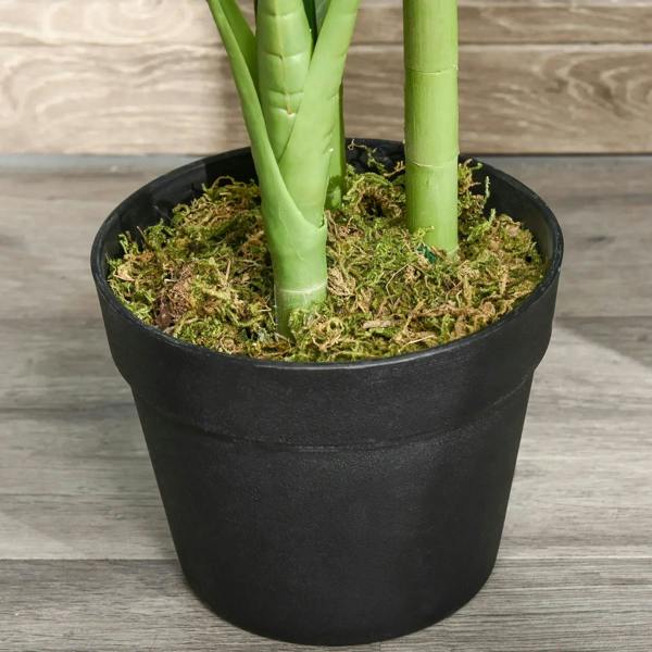 Close-up of artificial monstera base in black pot with faux moss