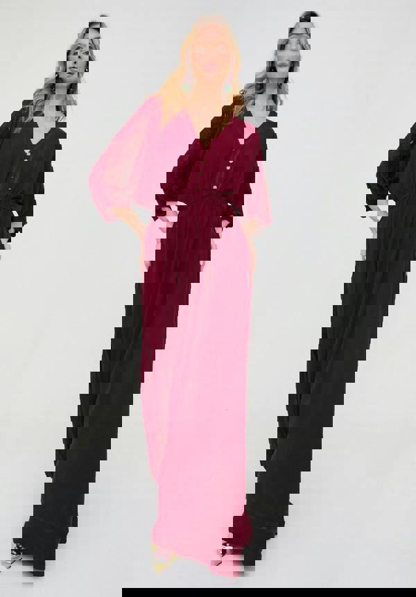 Woman wearing a burgundy dress on a white background