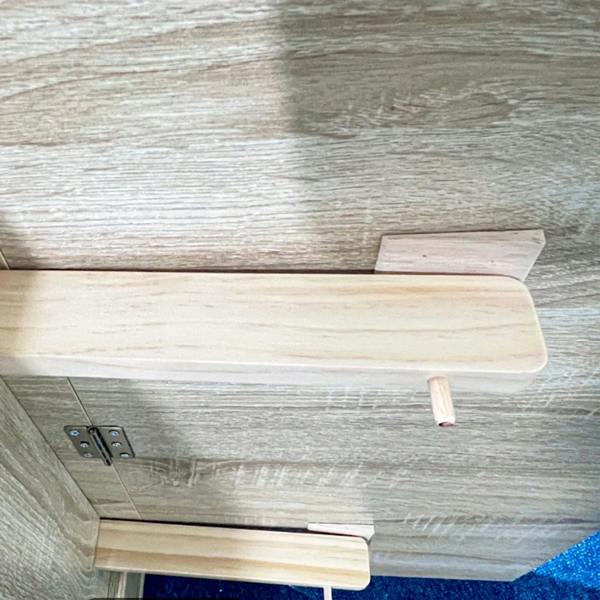 Oak-effect drop leaf hinge and underside detail with folded leaf support