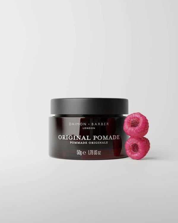 Jar of Original Pomade 50g with raspberries on grey background