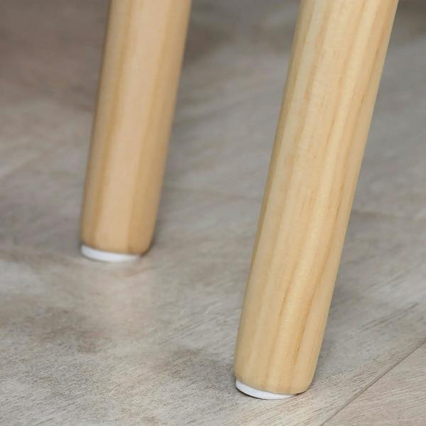 Solid light wood tapered legs with white tabletop base on a nesting side table