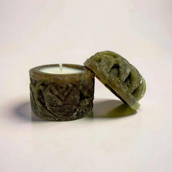 Decorative candle holder with a candle inside on a white background