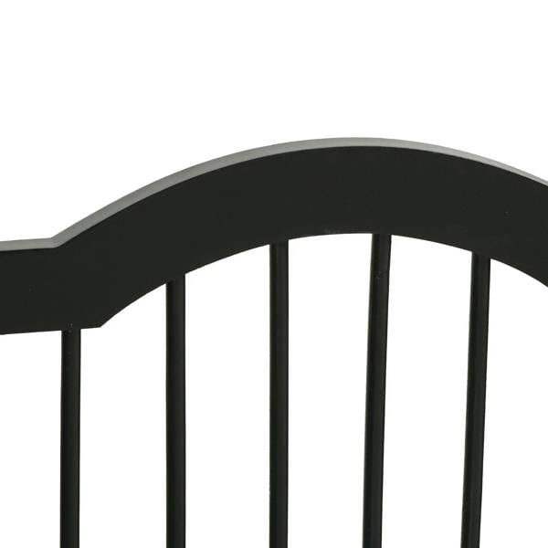 Close-up of black arched top rail and vertical bars on a foldable pet gate