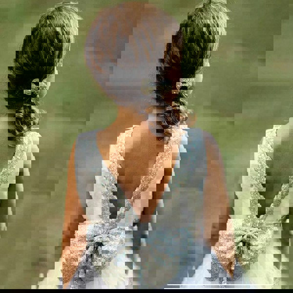 Girl wearing a silver party dress with sequin bow