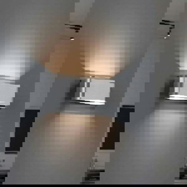 Silver up and down interior wall light  generating soft light in a modern home 