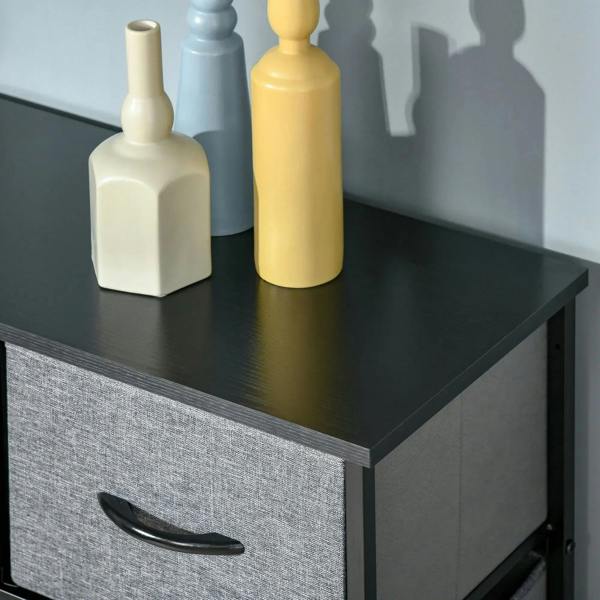 Grey fabric top drawer with curved black handle on a black-framed dresser