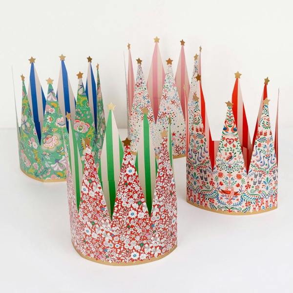 Four distinct Liberty print paper party crowns with gold foil star points arranged on a clean white background