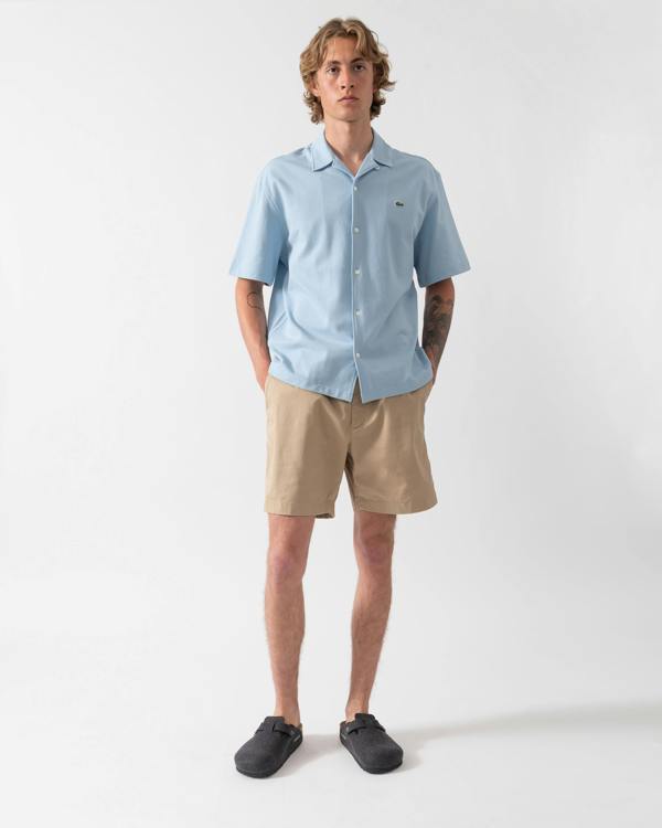 model wearing Lacoste Relaxed Fit Mens Stretch Cotton Shorts in Viennese 02S