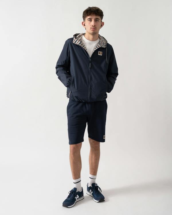 full length shot of a model wearing an Aquascutum Mens RLG Badge Reversible Sailor Jacket in Navy 11