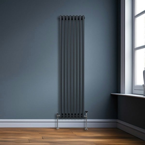 Traditional 3 column radiator in anthracite grey, featuring sleek vertical lines and a modern design, set against a blue wall