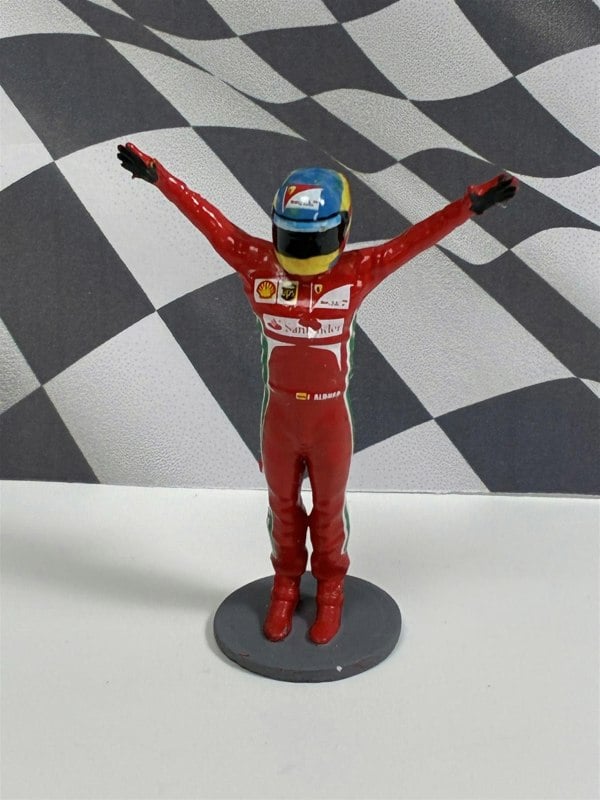 a toy figurine of a race car driver