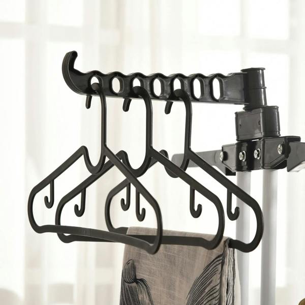 Close-up of black hanging hook bar holding clothes on the drying rack