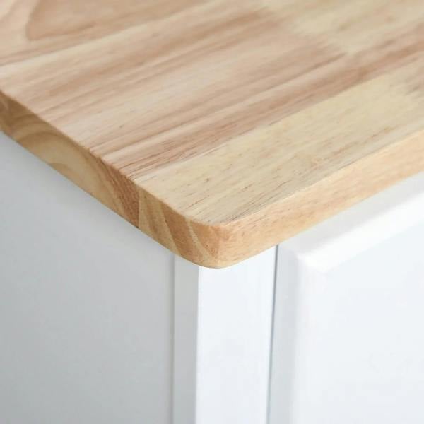 Light wood countertop with rounded edge on a white cabinet