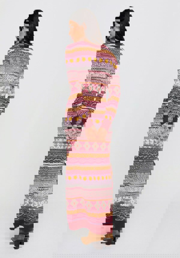 Woman wearing a patterned long dress on a white background