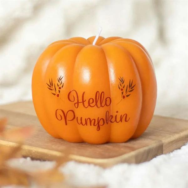Orange pumpkin-shaped candle with "Hello Pumpkin" text and small top wick