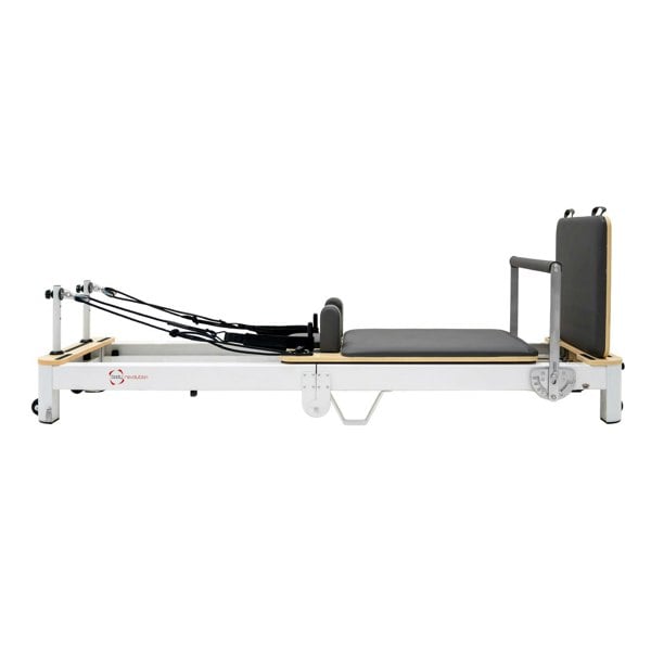 Aluminium Pilates reformer machine with a sleek white frame, padded black carriage, and adjustable resistance straps for versatile workouts
