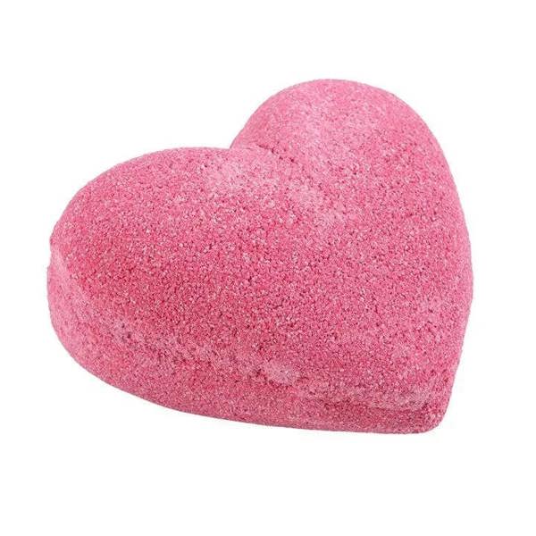 Pink heart-shaped bath bomb, side view showing dense fizzy-looking texture