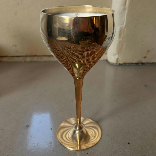 Gold goblet on a gray surface with a neutral background