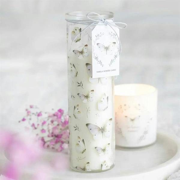 Vanilla tube candle in white glass with butterfly print, tied ribbon and scent label