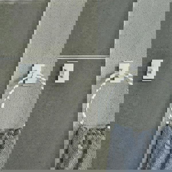 Single matt white towel hook on bathroom wall