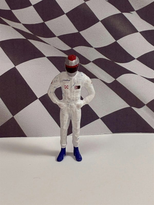 a toy figure in front of a checkered flag