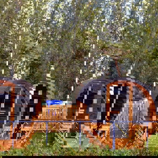 Barrel saunas with wooden fence