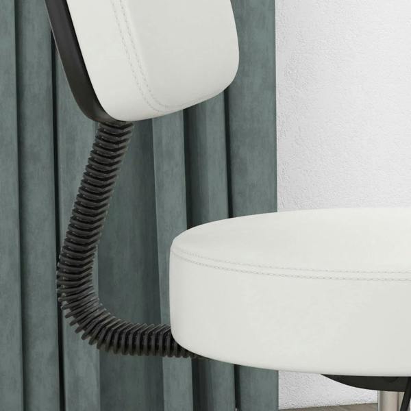 White padded salon chair seat with black spring support, close-up of cushion edge and stitching.