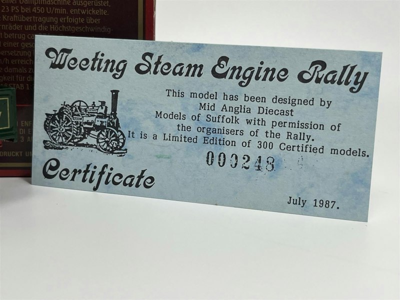 a blue certificate with black text and a train on it