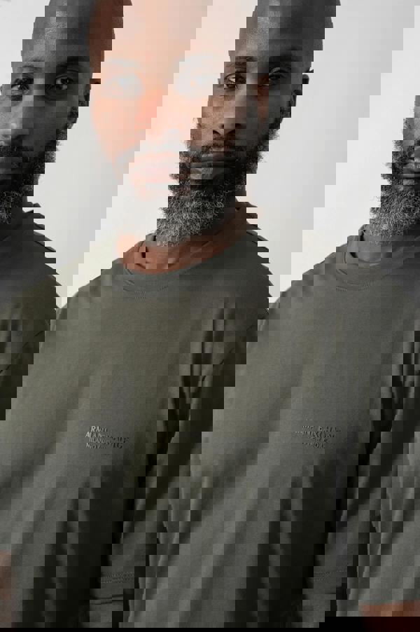 Close up shot of a Model wearing an Armani Exchange Mens T-Shirt with Small Milano/New York Logo in Chimera