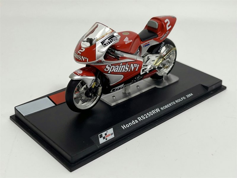 a red motorcycle on a black stand