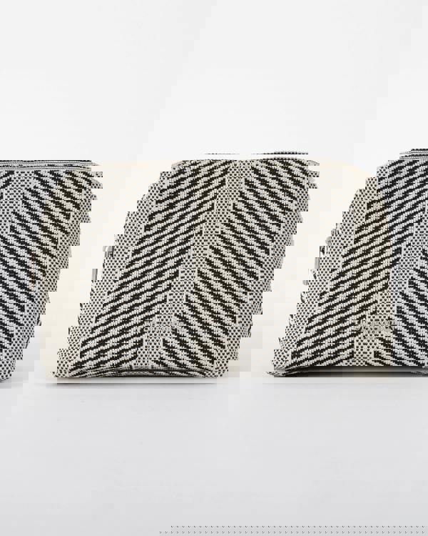 studio shot of Ilse Jacobsen Knitty Womens Knitted Makeup Bag in Milk Creme and Black