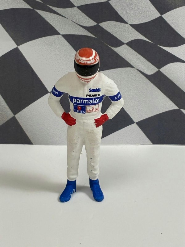 a toy figure of a race car driver