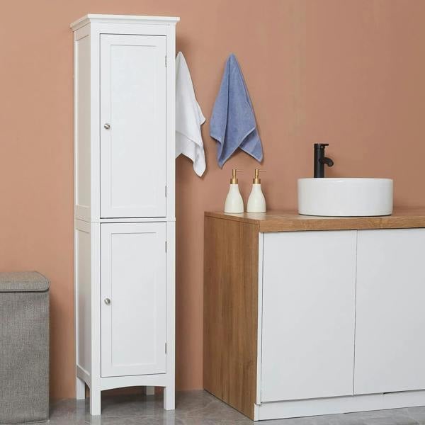 White tall cabinet with double doors and silver knobs beside sink cabinet