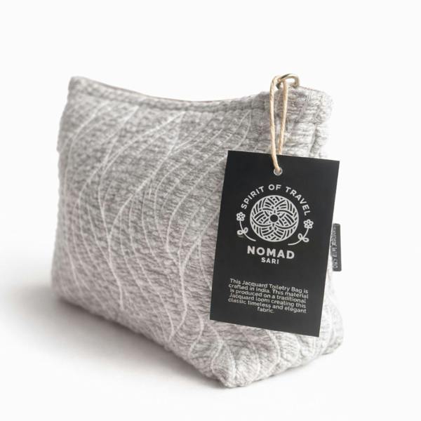 Light gray jacquard toiletry bag with leaf pattern and hanging brand tag