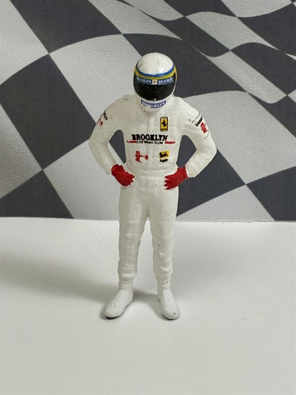 a toy figure of a race car driver