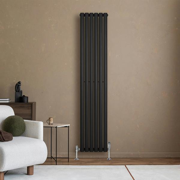 Sleek black oval single column radiator, 1800mm x 360mm, mounted against a textured beige wall, enhancing modern interior decor