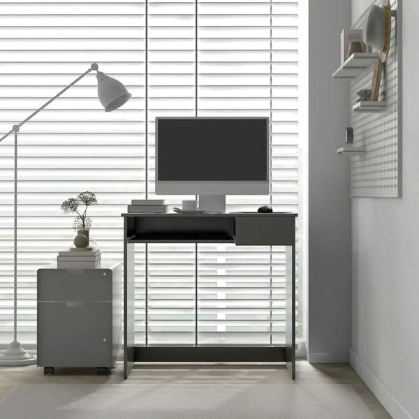 Grey computer desk with open storage cabinet and top work surface in a home office