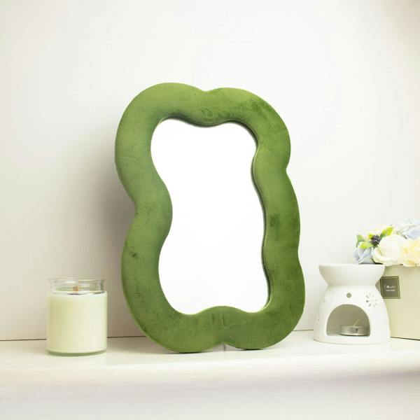 Cloud-shaped squiggly mirror in moss green with reflective center opening