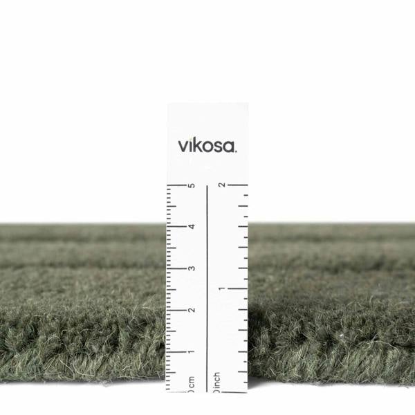 Dark green carpet with a ruler for scale and 'vikosa' branding.