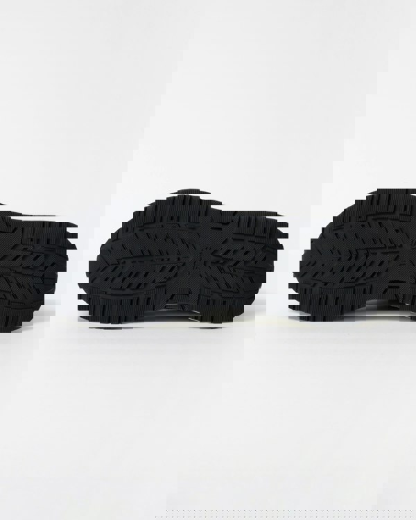 Black shoe sole with brand logo on a white background