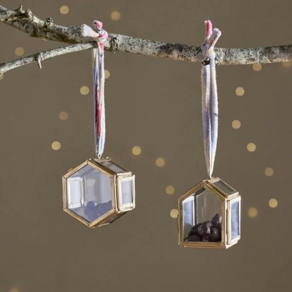 Set of two Malvern tiny brass and glass box ornaments hanging from a rustic branch with colorful sari silk ties.