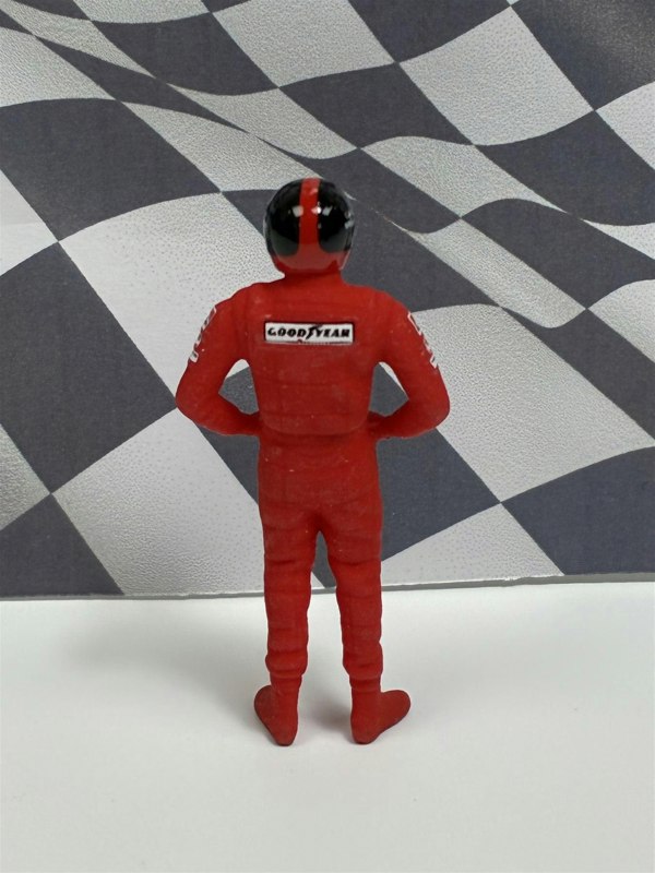 a toy figure of a race car driver