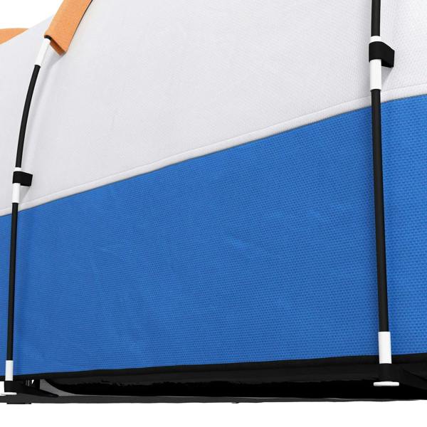 Close-up of orange and blue tent wall panel with white roof and poles