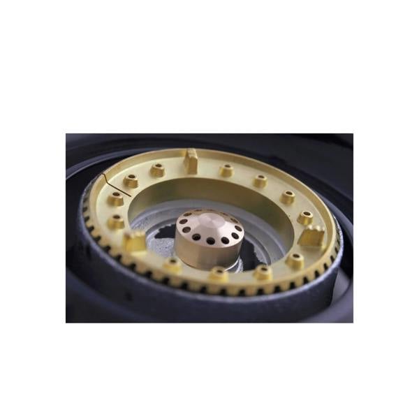 Close-up of a brass burner ring on a white background