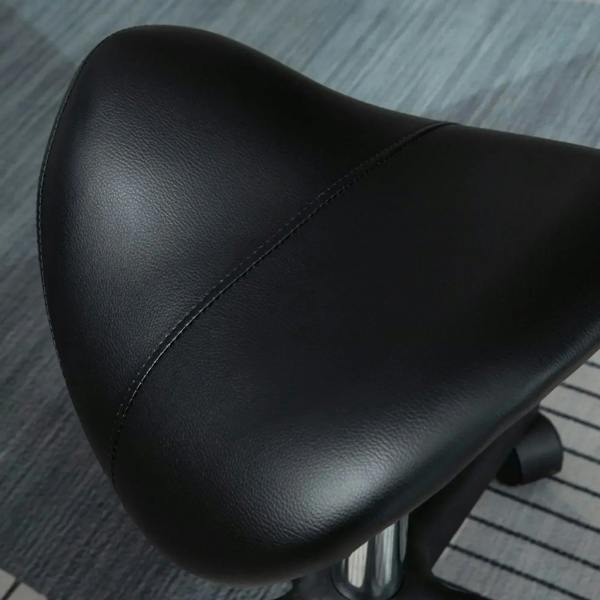 Close-up of black padded saddle seat with smooth PU texture and stitched edge
